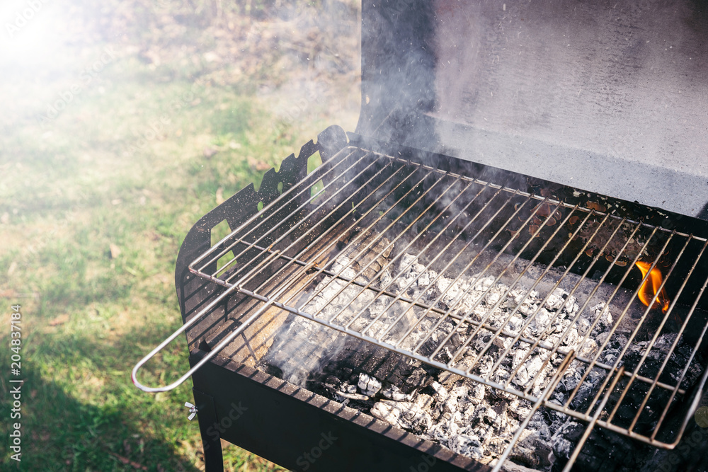 Grill with burning coals ready for barbecue outdoors Grill with burning coals ready for barbecue outdoors