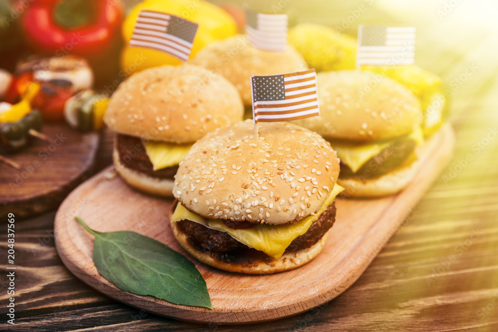 USA flags on hamburgers cooked outdoors on grill