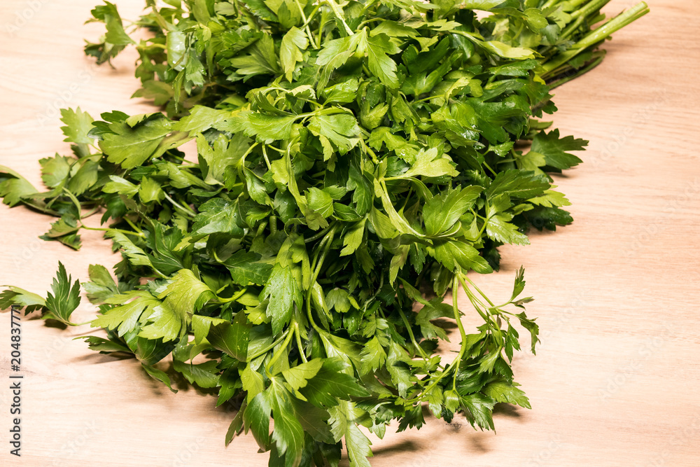 bunch of fresh parsley on a wooden board bunch of fresh parsley on a wooden board