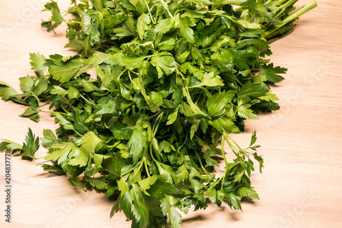 bunch of fresh parsley on a wooden board