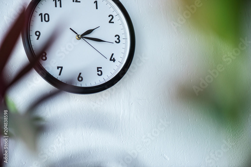 selective focus of black and white clock hanging on wall