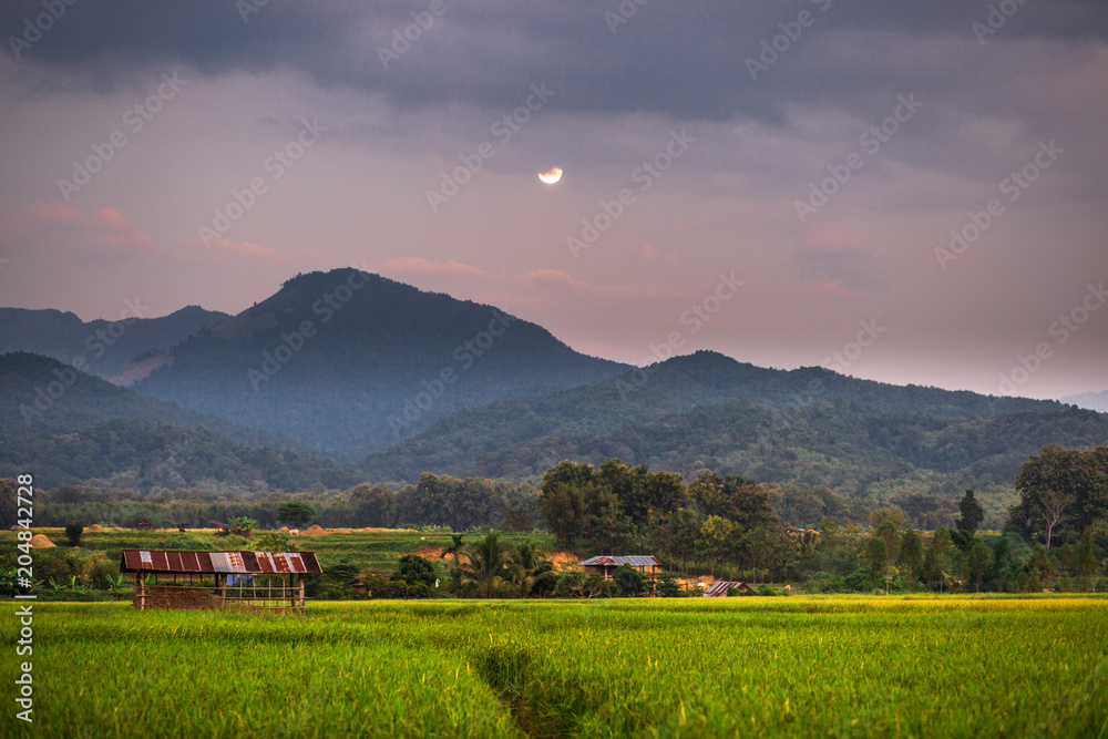 Twilight by the mountain. The beautiful view over the moonlight. The accommodation is beautiful in nature. Rural lifestyle in Pua District, Nan Province, Thailand.