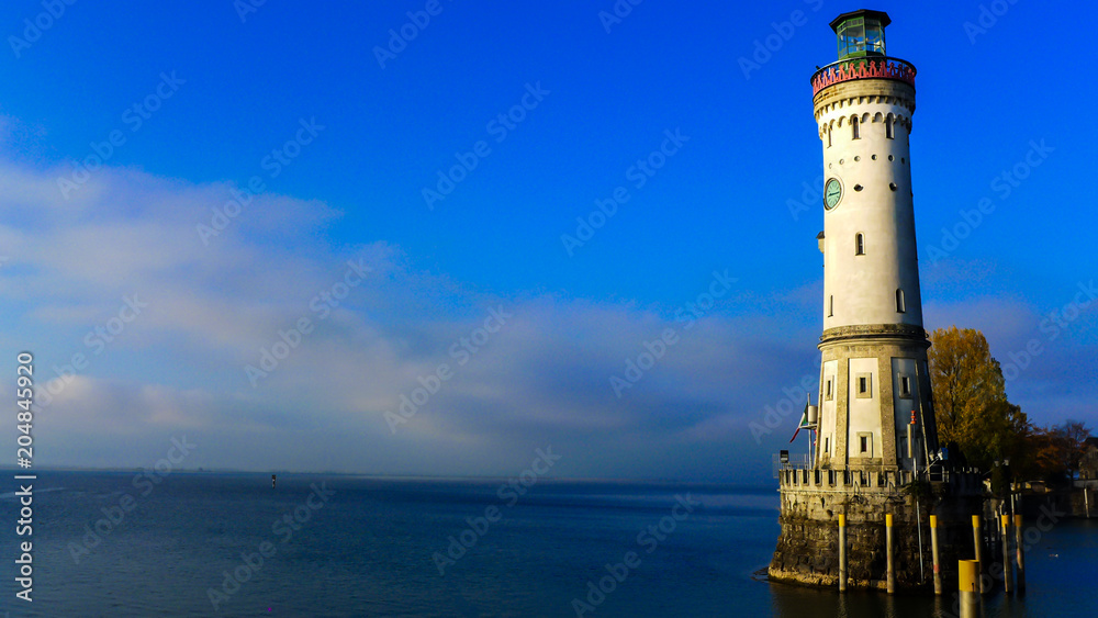view of Lindau Lighthouse with sea and blue sky background , Germany