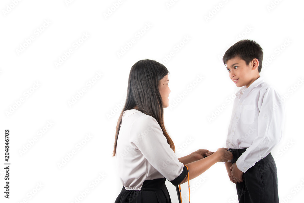 Mother is helping school boy wear neck tie ready for school on the first day