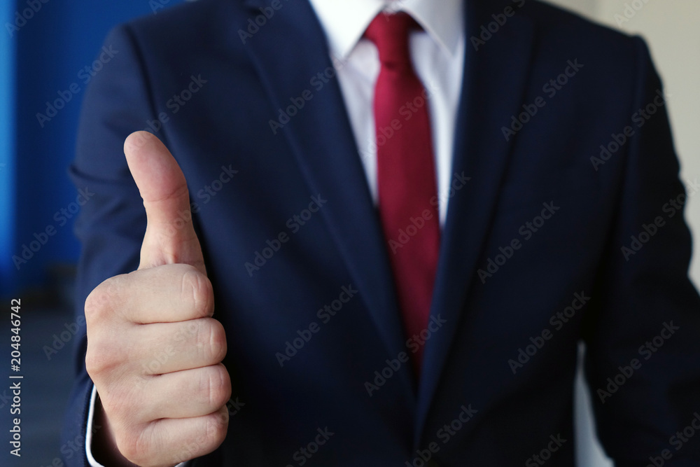 Businessman showing thumbs up - closeup shot Businessman showing thumbs up - closeup shot