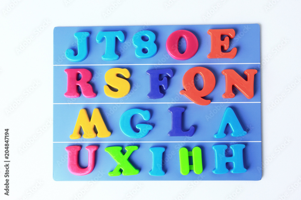 plastic magnetic colored english alphabet on blue background