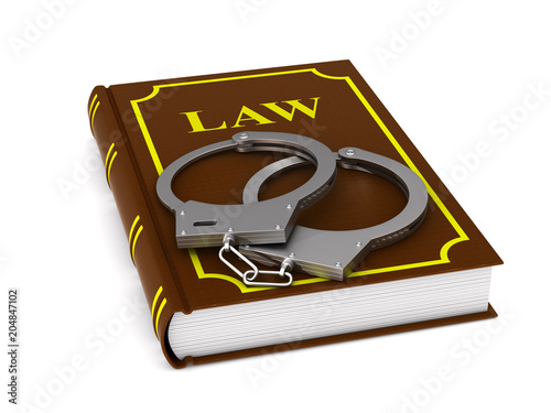 lawbook and handcuffs on wh...