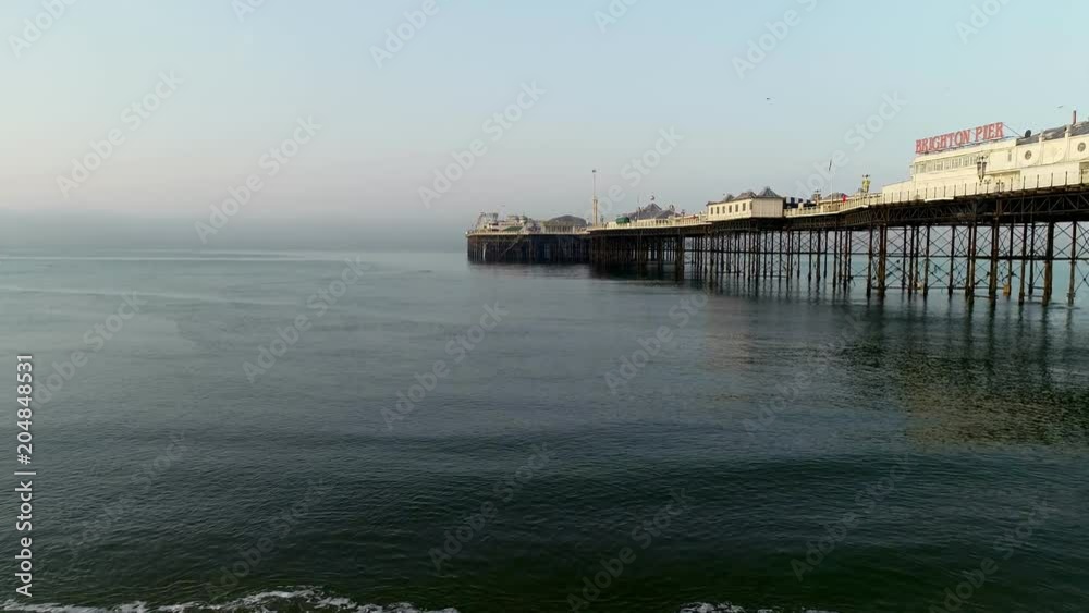 Drone flies forward and rises beside Brighton Pier Drone flies forward and rises beside Brighton Pier