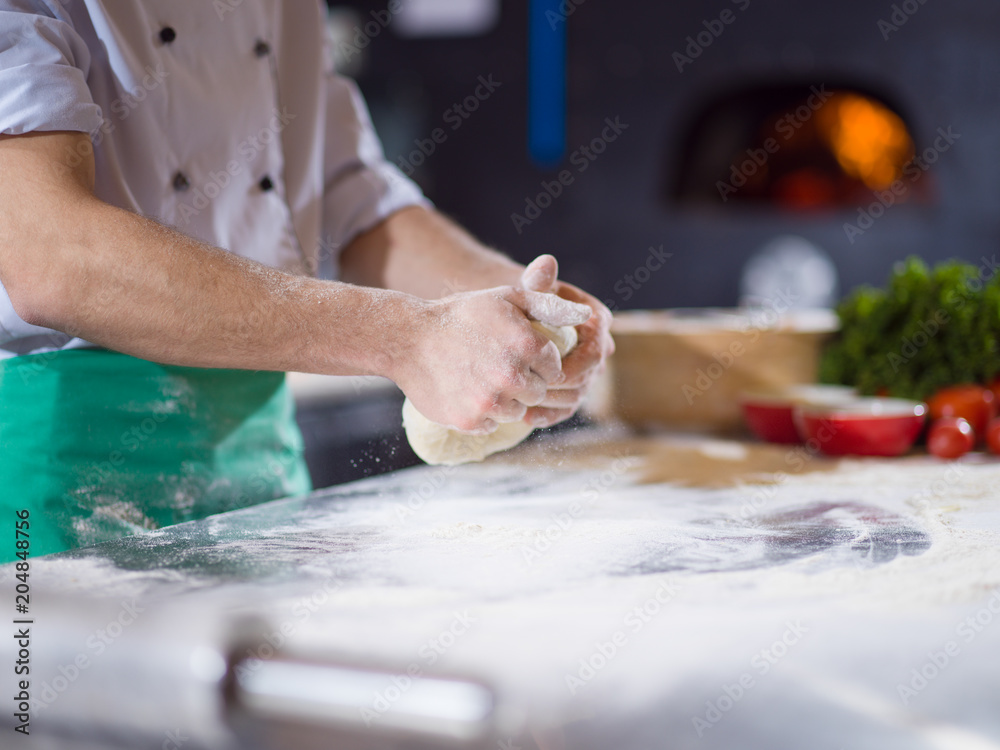 chef hands preparing dough for pizza