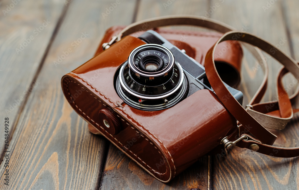 Old film camera in a brown leather case