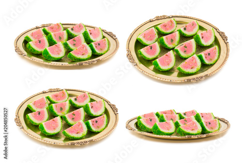 Collage of Indian Sweet Food Watermelon shaped Mawa Barfi in Vintage Golden Plate isolated on white background