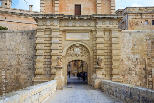 Malta, Mdina entrance gate. Tourists cross the footbridge to visit the historic fortified town.