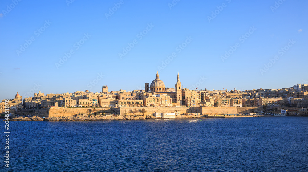 Valletta, Malta. Panoramic view of the historic island and the dome of Carmelite Church and St Paul`s tower.