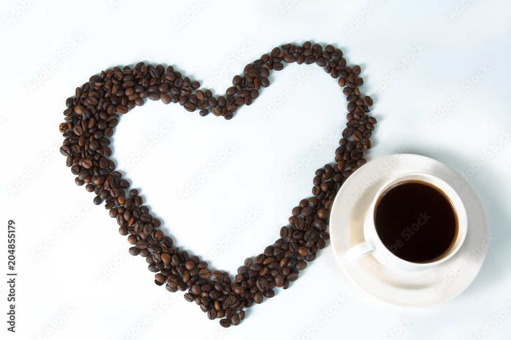 Coffee beans in the form of hearts with a cup Coffee beans in the form of hearts with a cup
