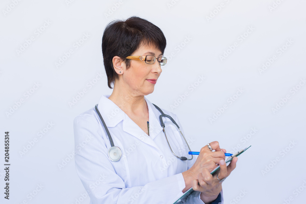 Medical doctor writing prescription over white background. Medical doctor writing prescription over white background.