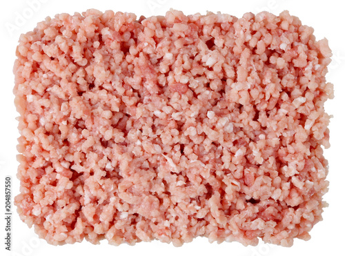 Fresh pork meat  heap is twisted on a  grinder in soft tender stuffing background isolated.