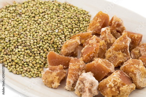 Group of jaggery with Coriander Seeds also Know as Gur, Goor or Gud isolated on White Background photo