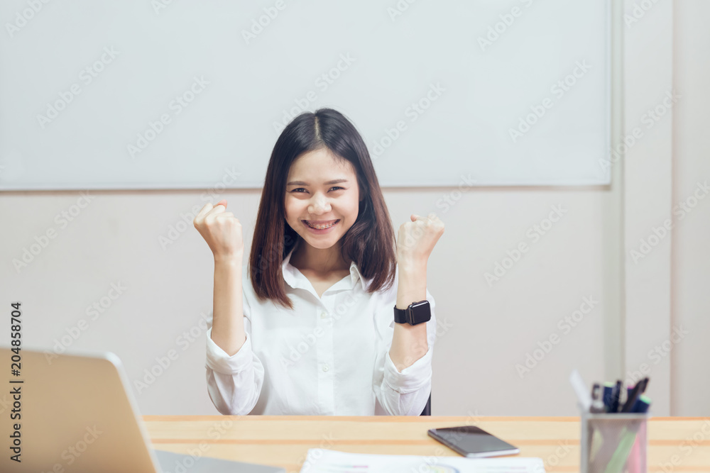Businesswomen are happy to succeed in work, and show document on the table in offiec background. Businesswomen are happy to succeed in work, and show document on the table in offiec background.