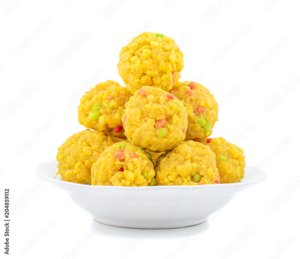 Laddu also know as laddoo, ladoo, laddo are ball-shaped sweets popular in the Indian festivals. Laddu are made of flour, minced dough and sugar with other ingredients. laddu on white background Laddu also know as laddoo, ladoo, laddo are ball-shaped sweets popular in the Indian festivals. Laddu are made of flour, minced dough and sugar with other ingredients. laddu on white background