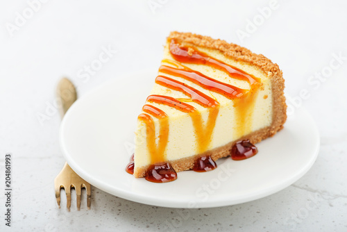 Slice of cheesecake with caramel sauce.