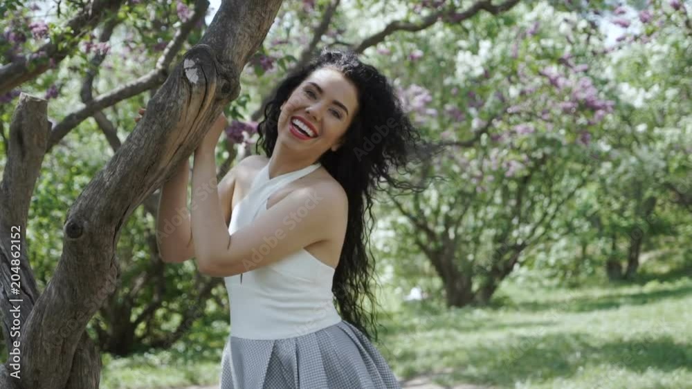 Happy brunette in summer garden Happy brunette in summer garden