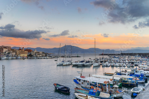 Sunset in Torre del Greco port near Naples, on background Sorrento peninsula