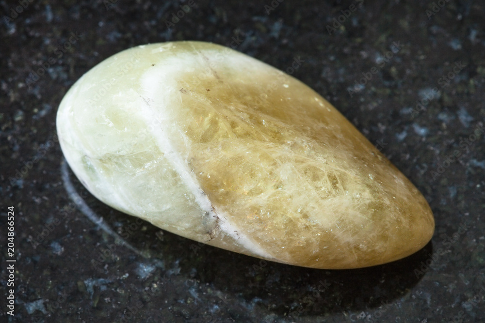 tumbled Prasiolite (green quartz) stone on black tumbled Prasiolite (green quartz) stone on black