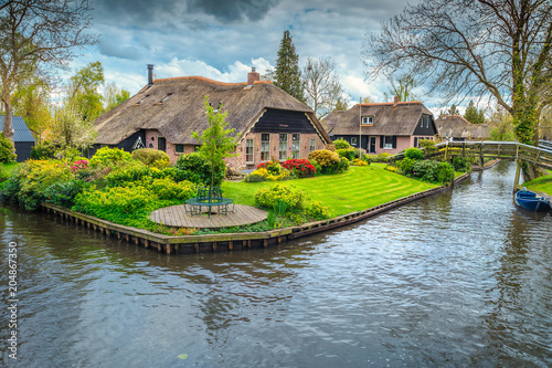 Dutch village with colorful ornamental garden and spring flowers, Giethoorn