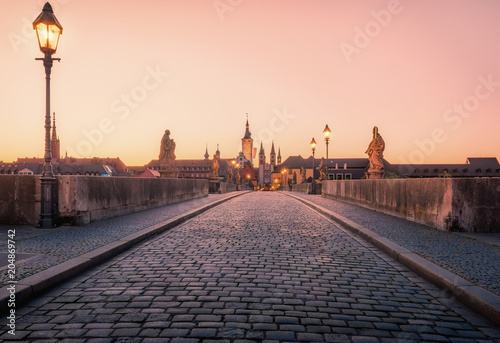 Scenic sunrise morning view of the Old Main Bridge over the Main river in the Old Town of Wurzburg, Bavaria, Germany - part of the Romantic Road photo