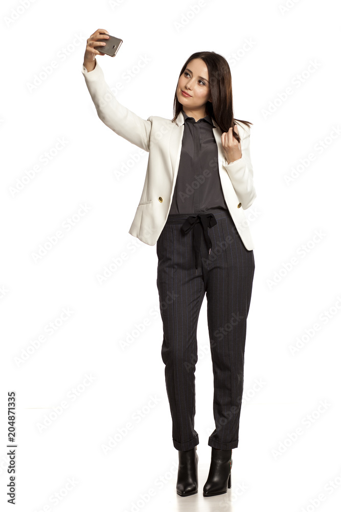 pretty businesswoman taking selfies on white baclground pretty businesswoman taking selfies on white baclground