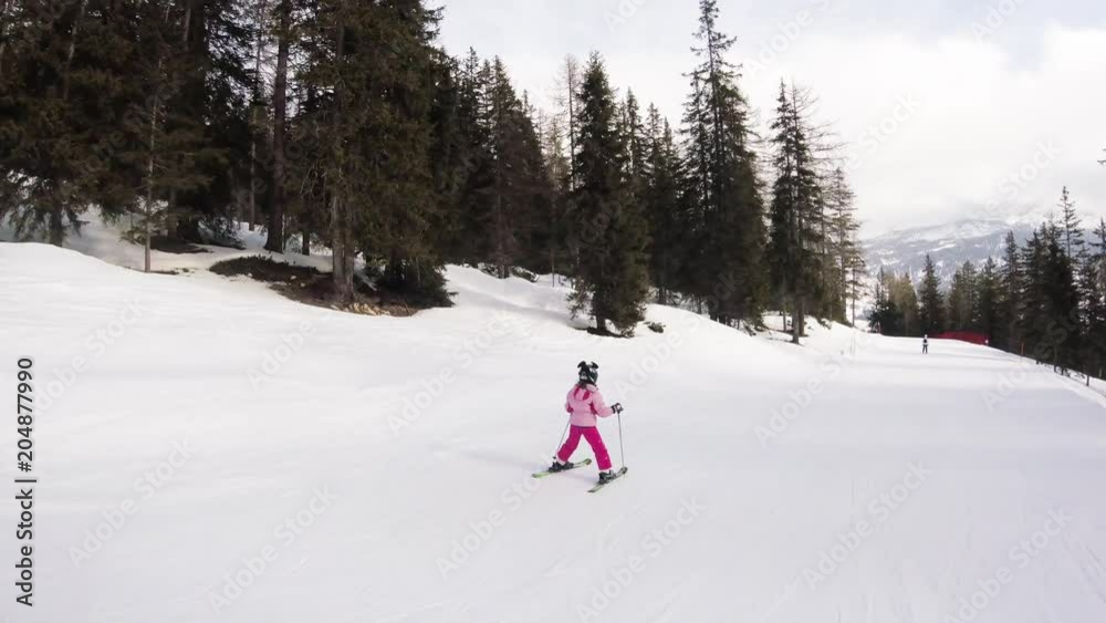 A little girl skiing in mountains, action camera footage A little girl skiing in mountains, action camera footage