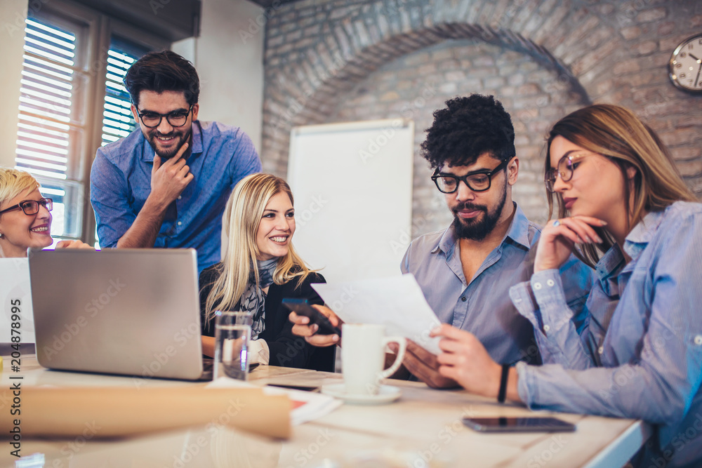  Group of young business people in smart casual wear working together in creative office