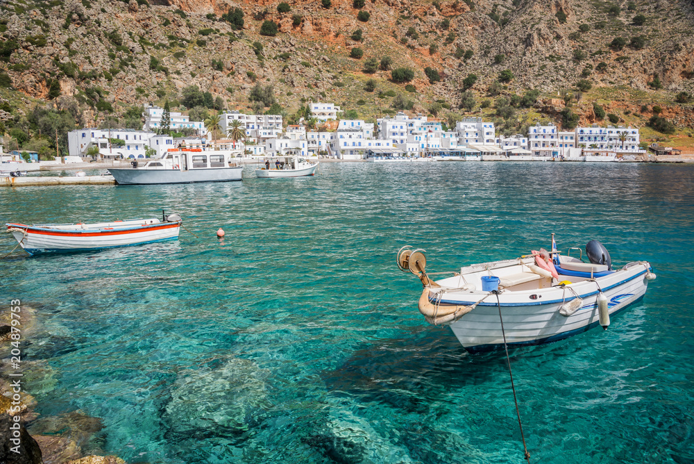 Fishing boats and the scenic village of Loutro in Crete, Greece