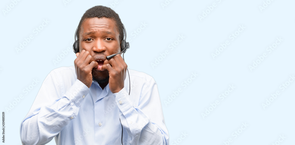 Black man consultant of call center terrified and nervous expressing anxiety and panic gesture, overwhelmed Black man consultant of call center terrified and nervous expressing anxiety and panic gesture, overwhelmed
