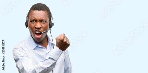 Black man consultant of call center irritated and angry expressing negative emotion, annoyed with someone © Krakenimages.com