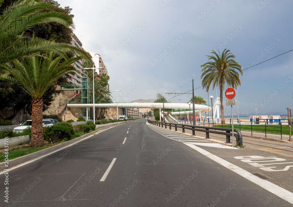 urban infrastructure on the seafront of Alicante, the tram line and a futuristic white bridge for pedestrian cycle crossings