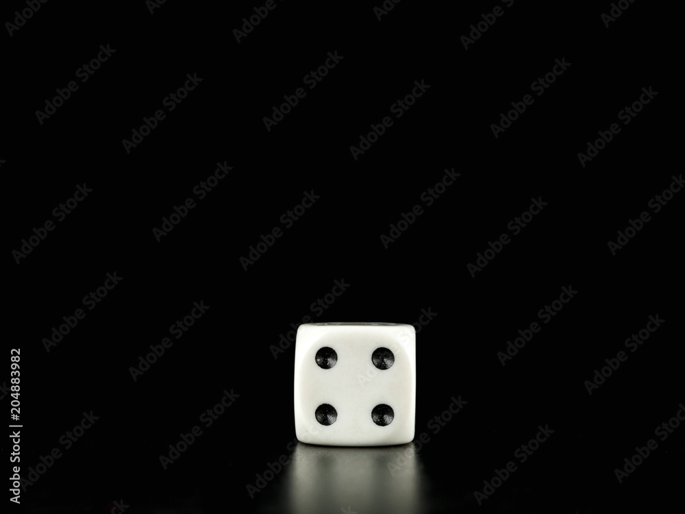 Game die isolated against black background, face with number four Game die isolated against black background, face with number four