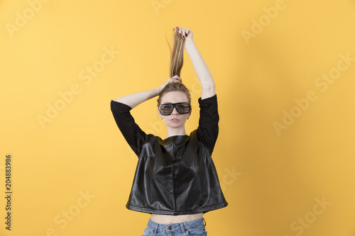 Beautiful young girl posing on yellow background © makedonski2015