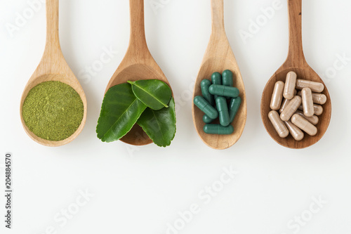 Fototapeta Naklejka Na Ścianę i Meble -  Herbal medicine in spoon on white background