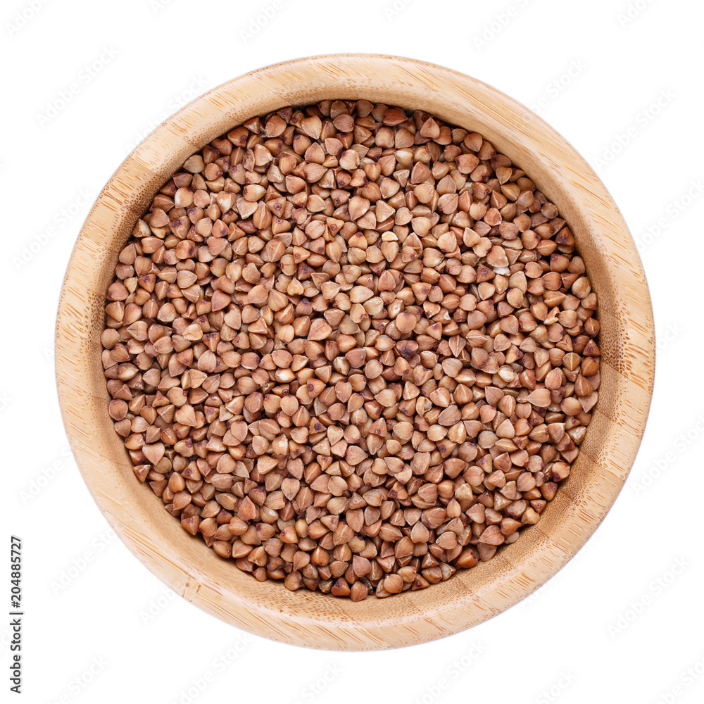 Roasted brown buckwheat grains in wooden bowl isolated on white. Top view. Roasted brown buckwheat grains in wooden bowl isolated on white. Top view.
