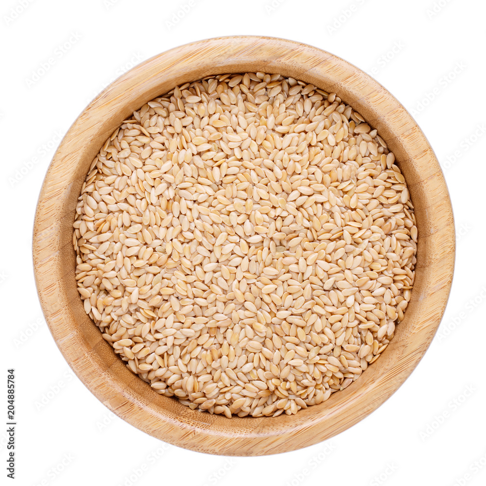 Golden flax seeds in wooden bowl isolated on white. Top view. Golden flax seeds in wooden bowl isolated on white. Top view.