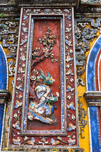 Vietnam, Hue. Decoration decorated with pieces from broken ceramic dishes at Imperial City on the one of five entrance gates to the Forbidden city complex in Citadel.
