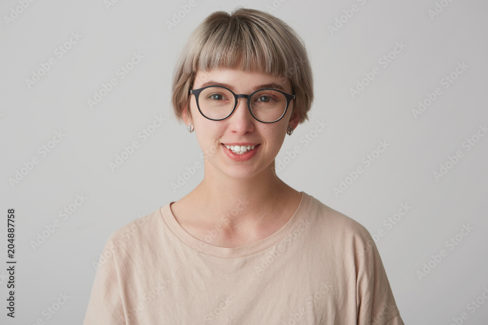 Happy cheerful young woman wears casual t shirt and glasses get a good news from her boyfriend aboit holidays. Postrait of smiling cute girl Happy cheerful young woman wears casual t shirt and glasses get a good news from her boyfriend aboit holidays. Postrait of smiling cute girl