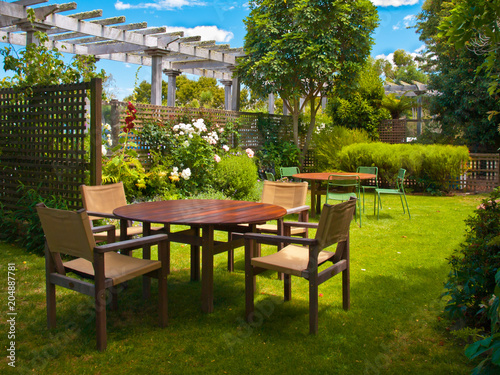 dining table set in lush garden © creativenature.nl