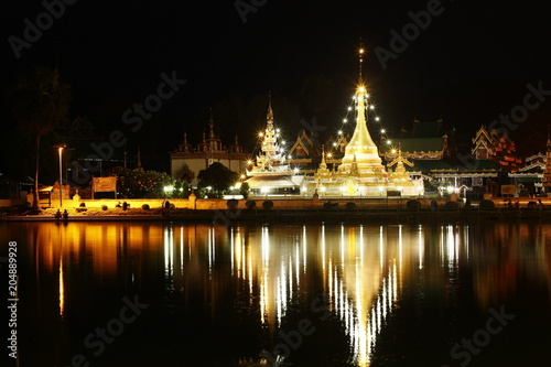 Buddhist temple stupa at night time covered in lights, Northern Thailand, Southeast Asia