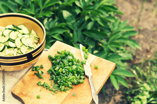 Sliced green onions and salad with cucumbers and cabbage photo