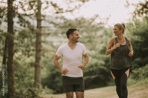 Couple jogging outdoors in nature