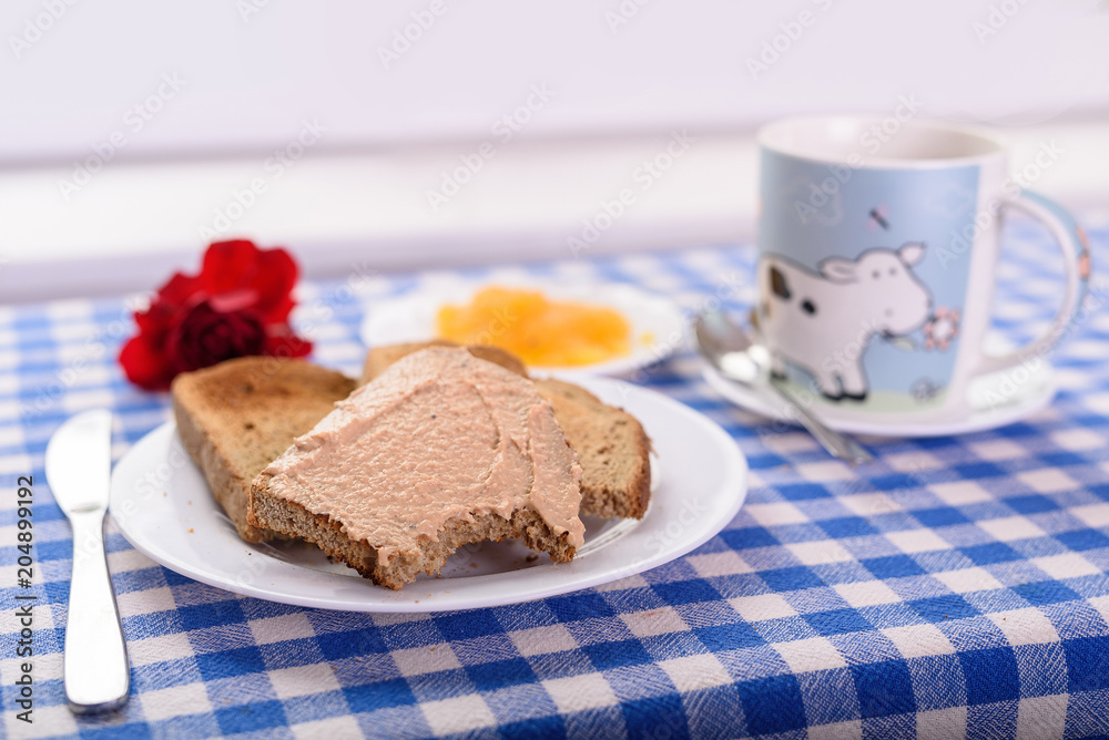 a cup of tea, a piece of toast with honey for breakfast a cup of tea, a piece of toast with honey for breakfast