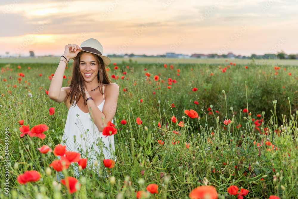 Happy woman in the field of red poppies Happy woman in the field of red poppies