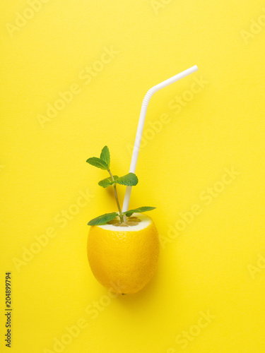 Lemon with white straw and mint.
